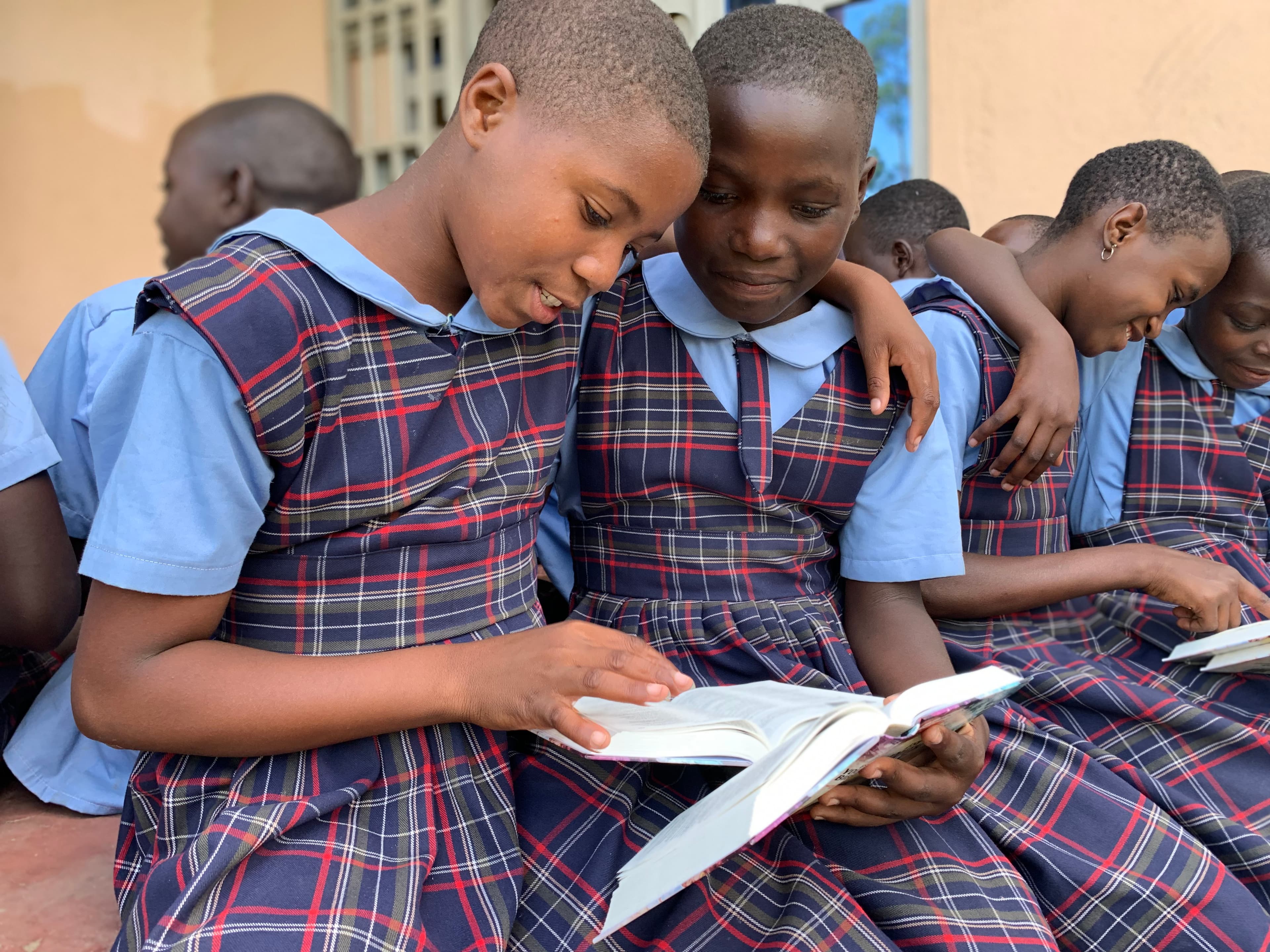 Two girls reading a bible
